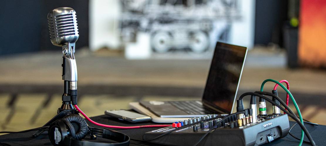 Podcasters header image laptop and mic
