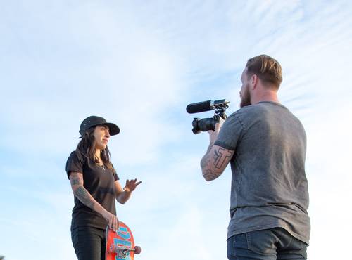 Skateboarder being interviewed under a bright sunny sky with inset of the F1's easy-to-read LCD screen