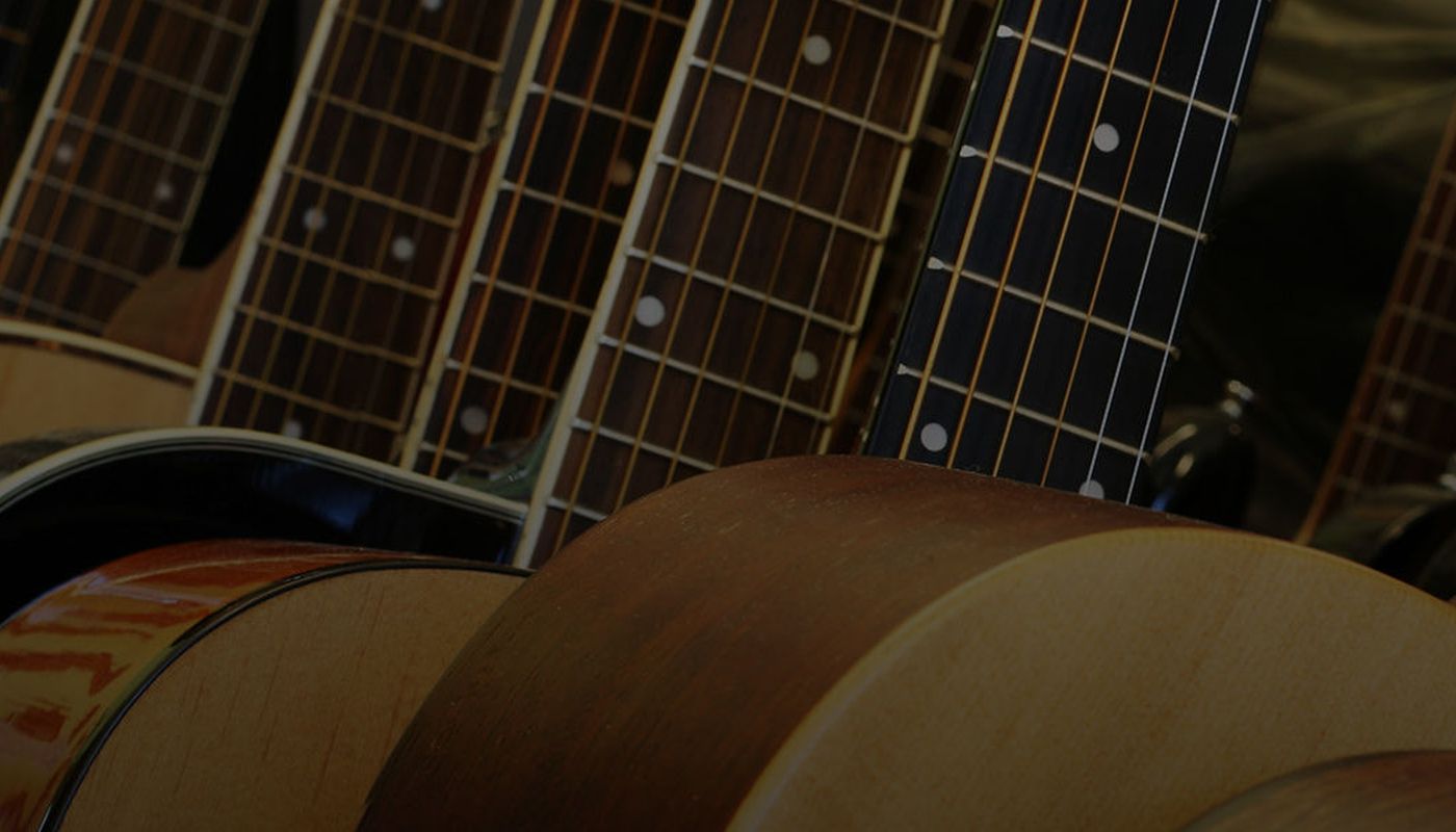 Row of Acoustic Guitars