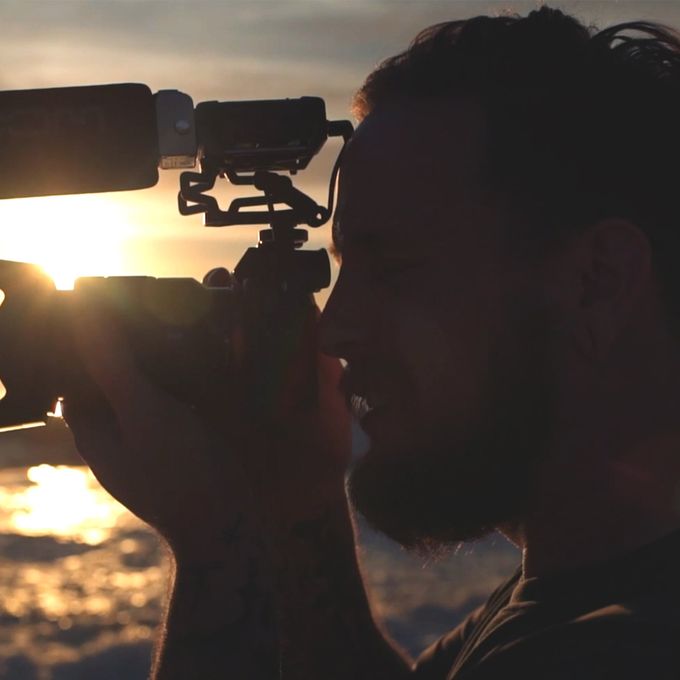 videographer on beach with sun setting using DSLR camera with F1-SP attached