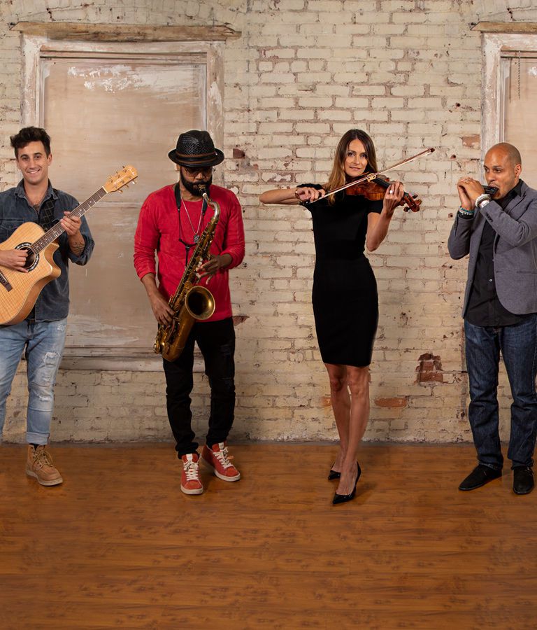 Four people playing various instruments including acoustic guitar, saxophone, violin and harmonica