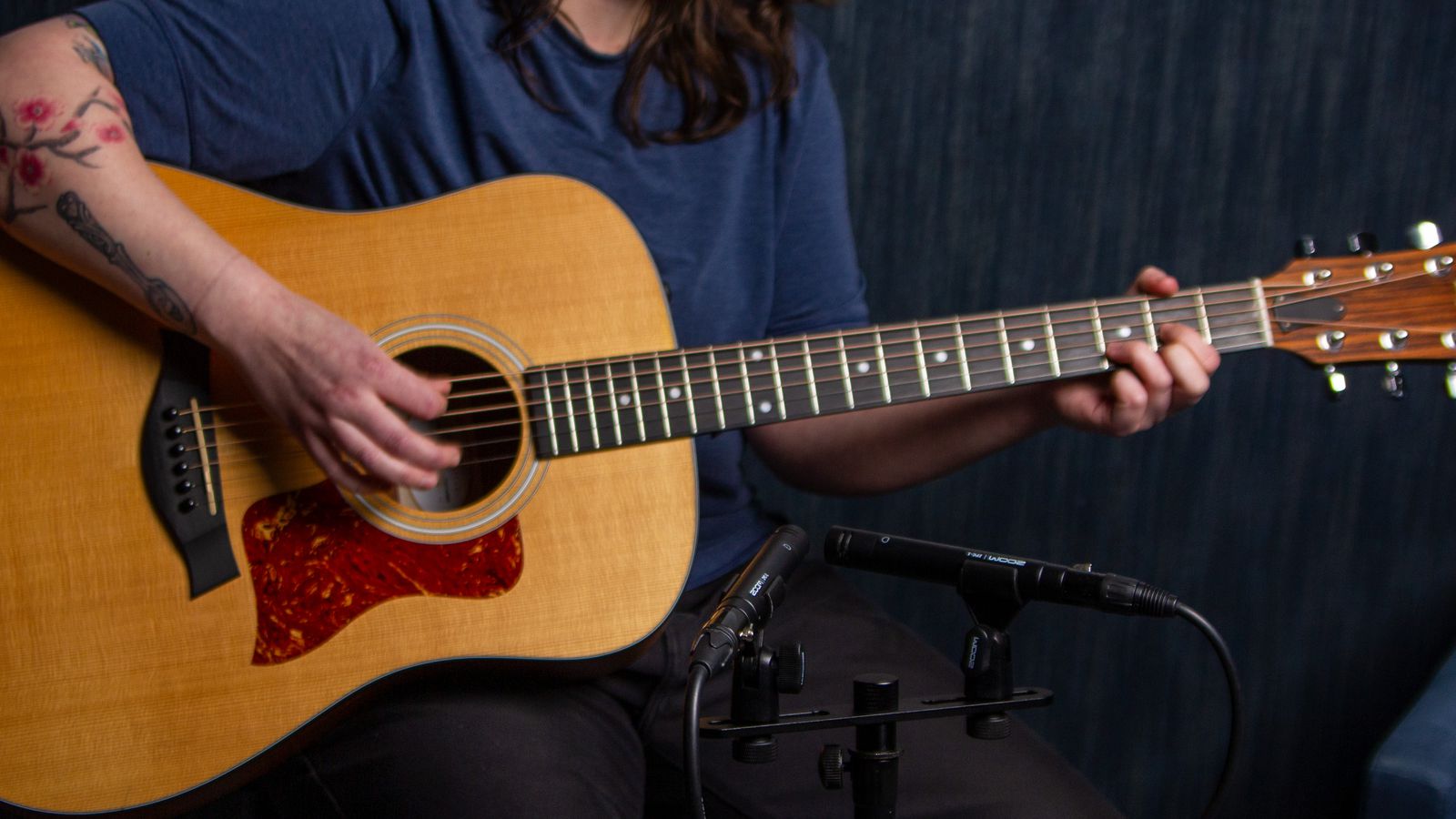 Musician playing an acoustic guitar with ZPC-1 mics used for recording