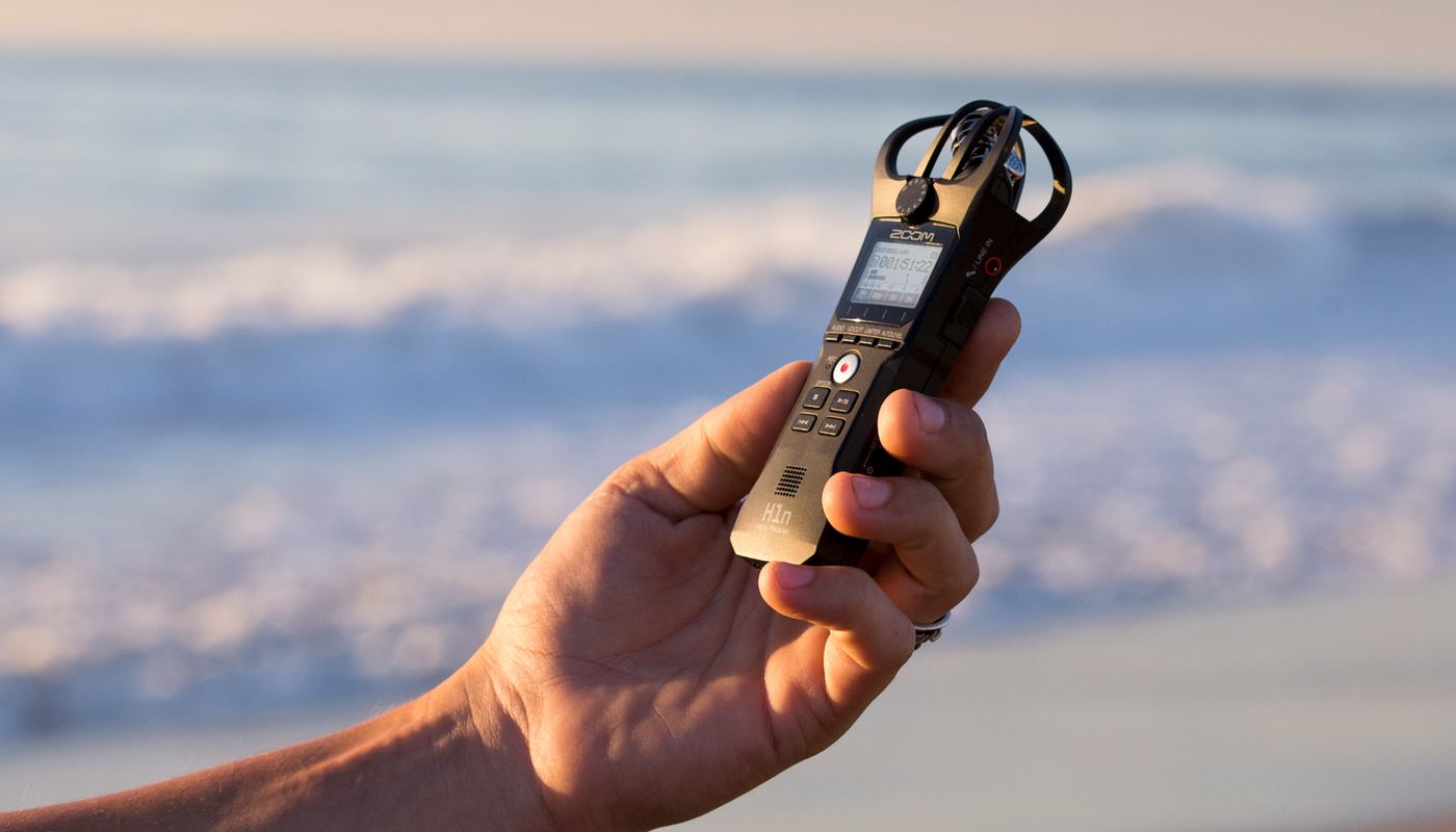 hand holding the H1n on the beach