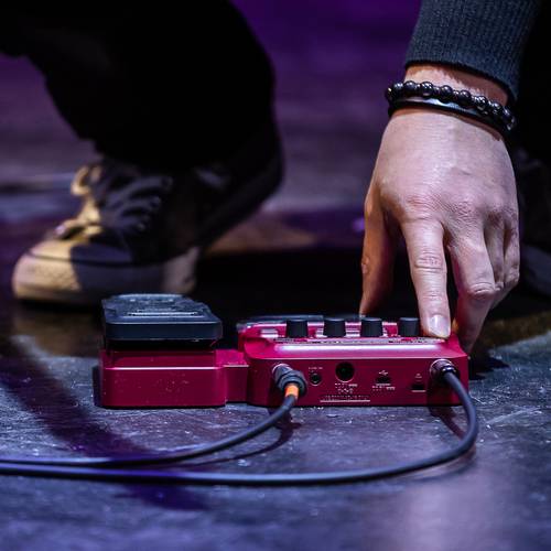 bassist using pedal on floor