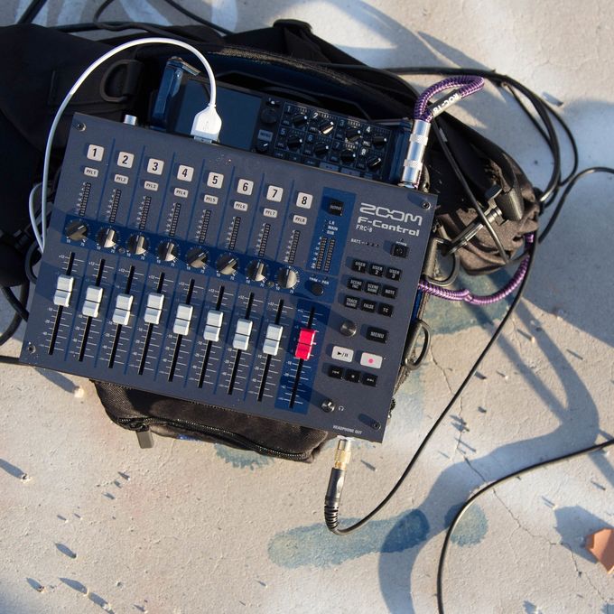 F-Control with headphones connected on the ground in the desert