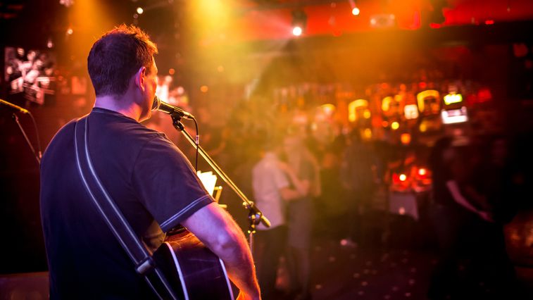 guitarist playing in a bar