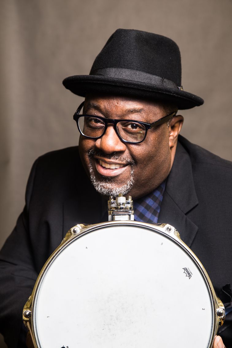 Carl Allen posing with a drum head