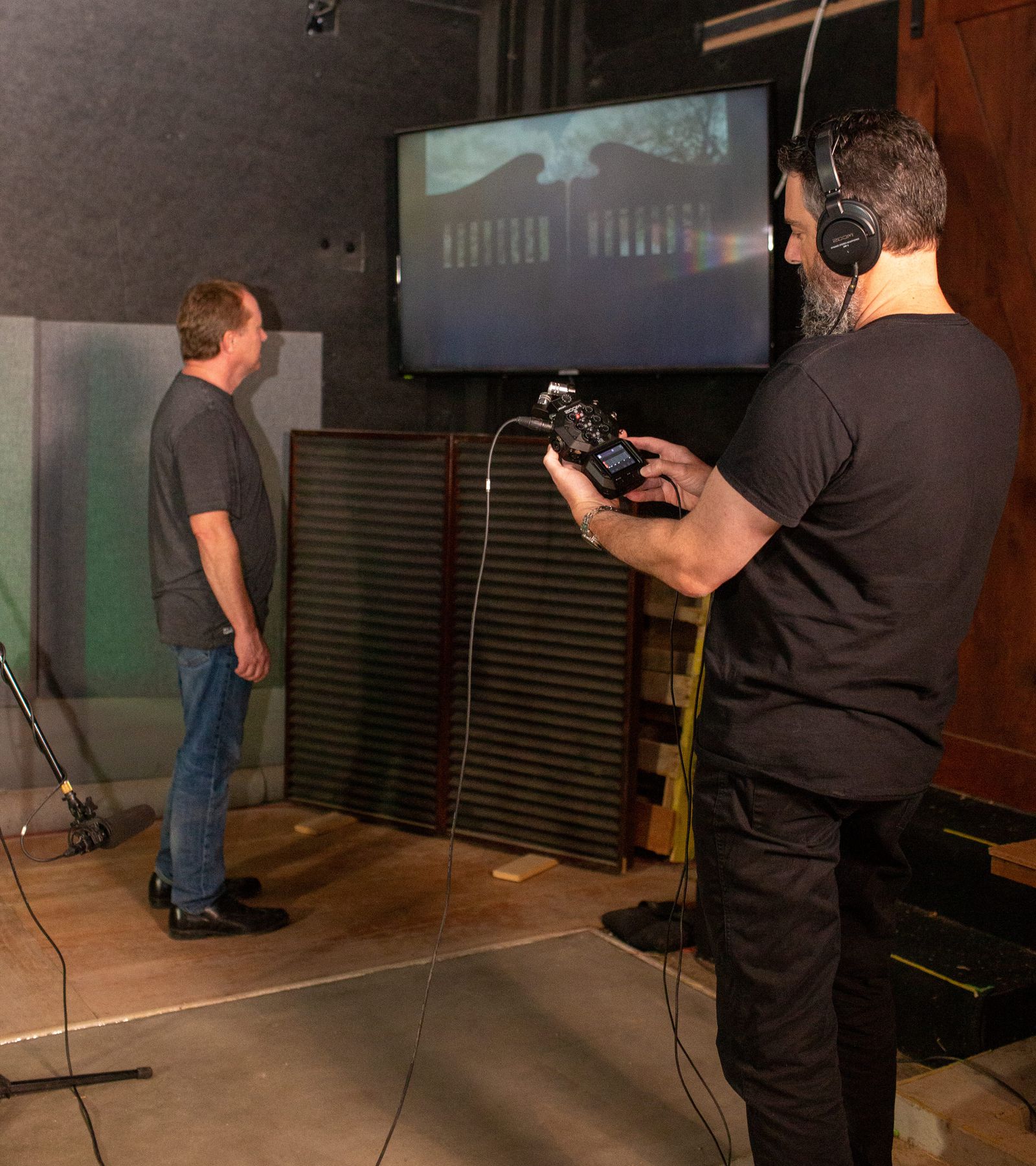 Foley artists creating sounds while engineer records