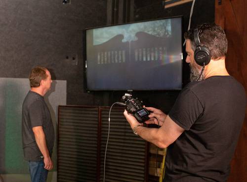 Foley artists creating sounds while engineer records