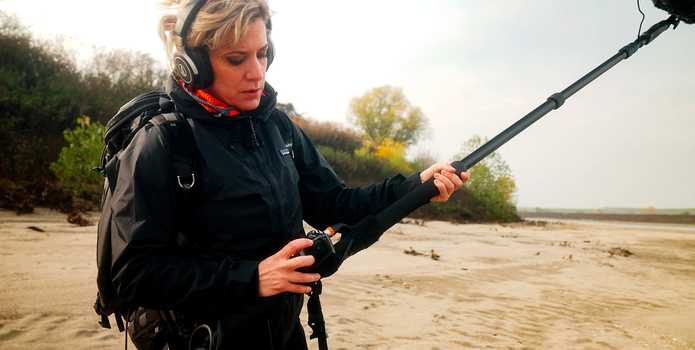 A recording engineer holding a boom mic and recording with an F3.