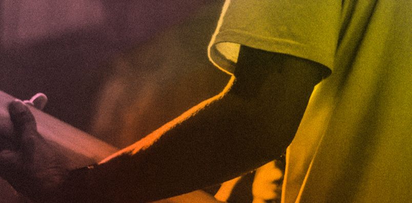 A guitarist playing the guitar on stage.