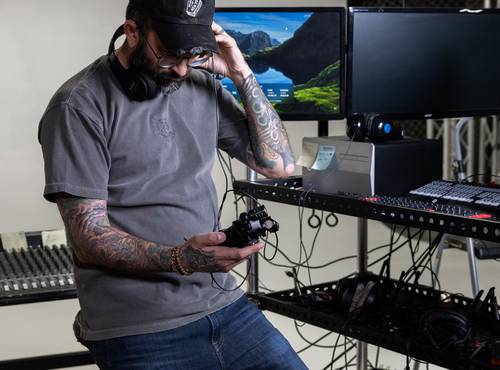 Film producer listening back to the recording on the H5studio through headphones