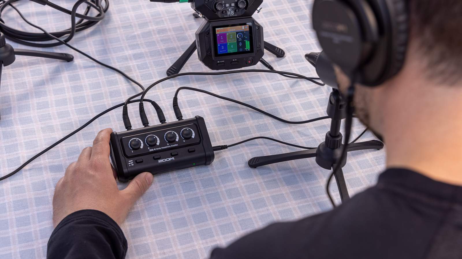 Podcaster using the ZHA-4 Headphone Amp connected to the Zoom H8