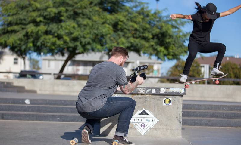 Filmmaker and skateboarder at work