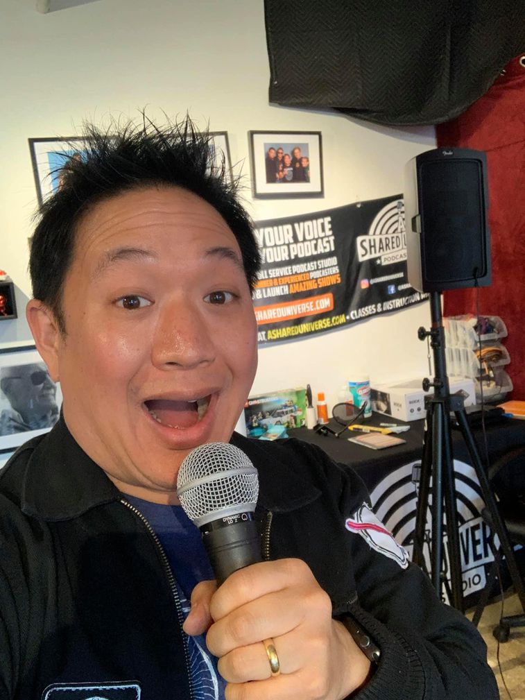 Ming Chen speaking enthusiastically into a microphone!