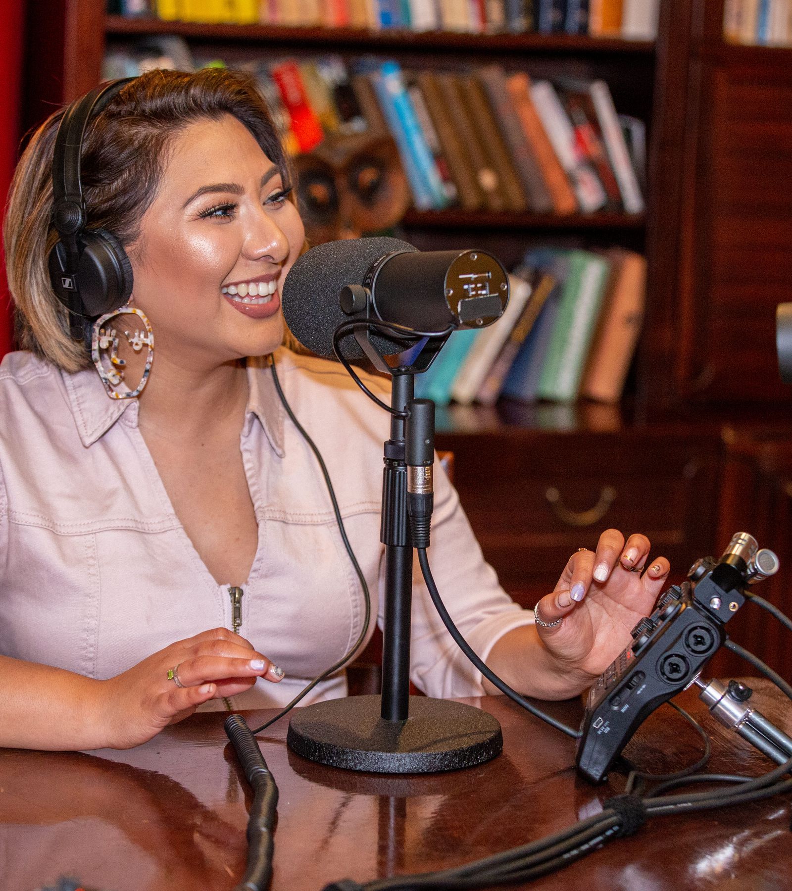 H6 being used for podcasting in a library. H6 is connected to two mics, a headphone amp and a laptop, for live broadcast.