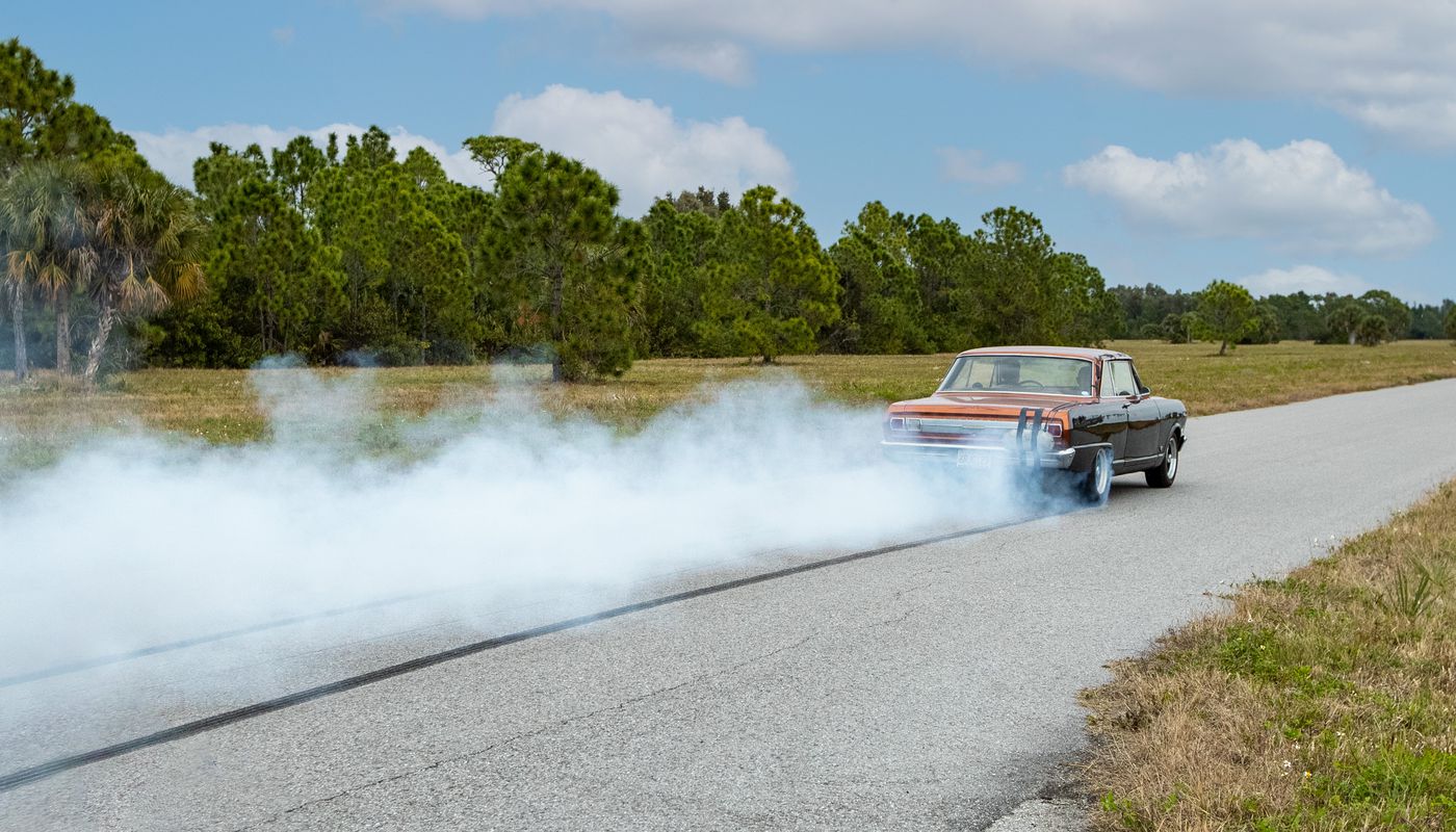 Hot rod being recorded during a burnout