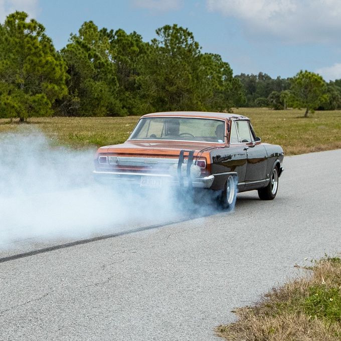 Hot rod being recorded during a burnout