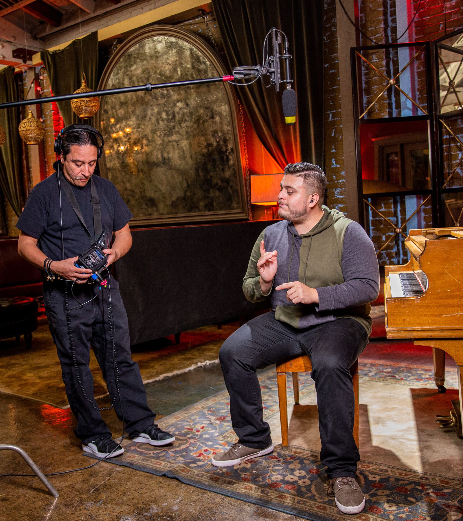 Soundman using a H6 to monitor sound on the set of a video production. H6 is connected to a boom pole/mic and a wireless lav.