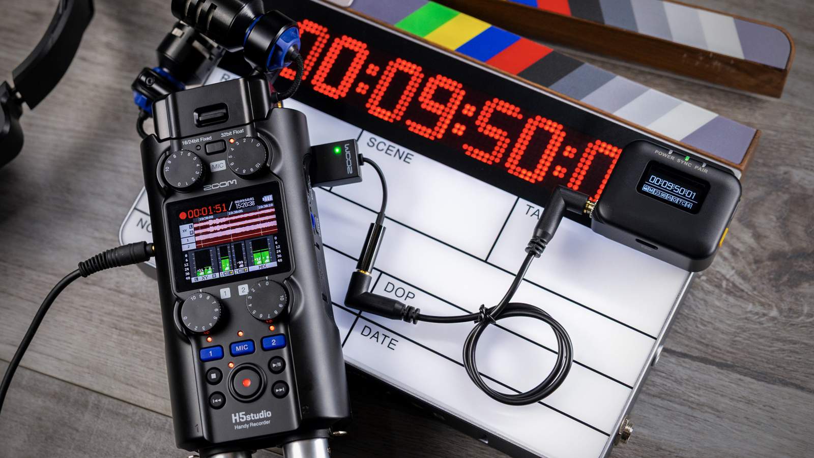 The TCA-1 Timecode Adapter connected to an H5studio Handy Recorder and a master clock.