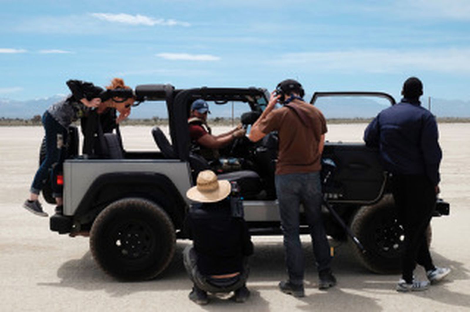 Crew gathered around a truck at the shoot