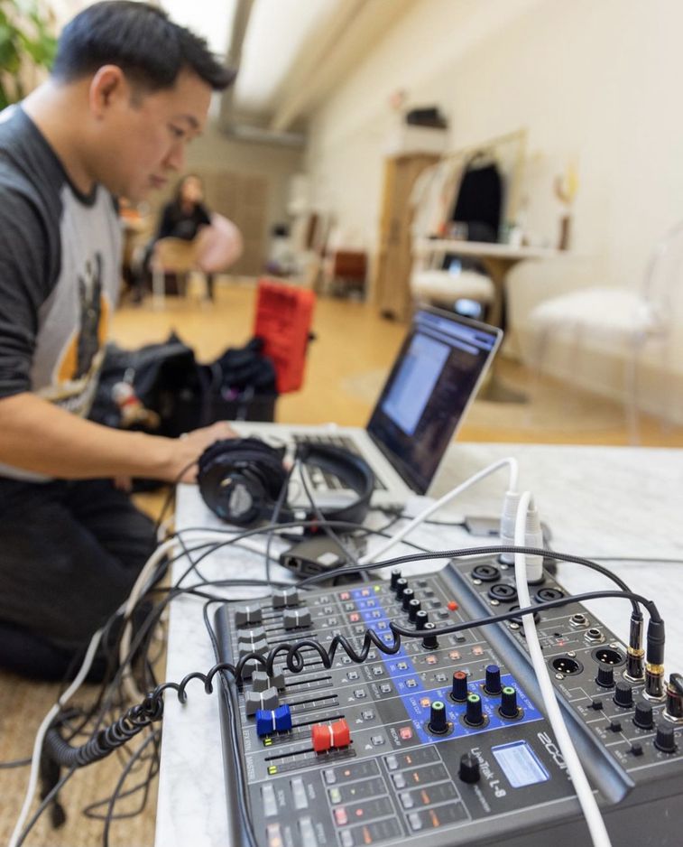 Ming Chen looking at a laptop that is connected to an L-8