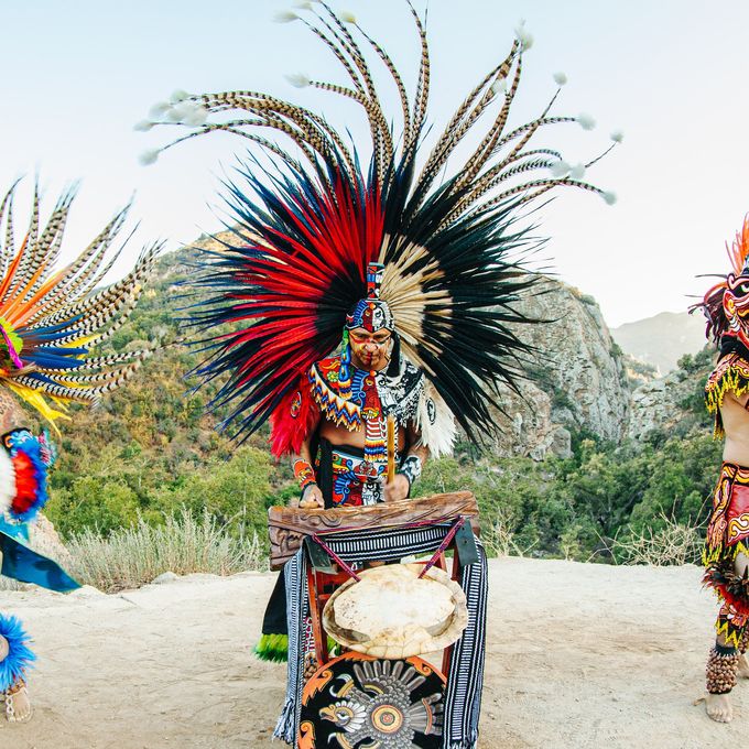 Traditional Aztec performance with musicians and dancers in costume.