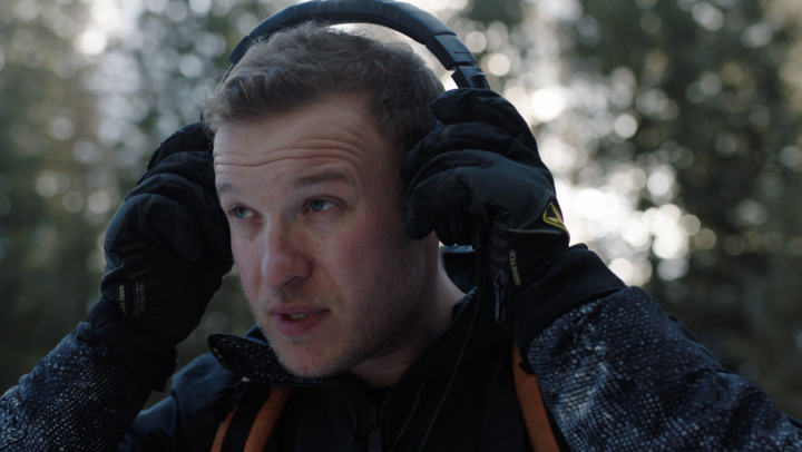 ross lara adjusting his headphones
