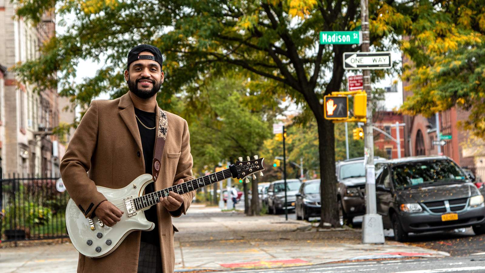 Ricardo Ramos posing with his guitar in Brooklyn NY