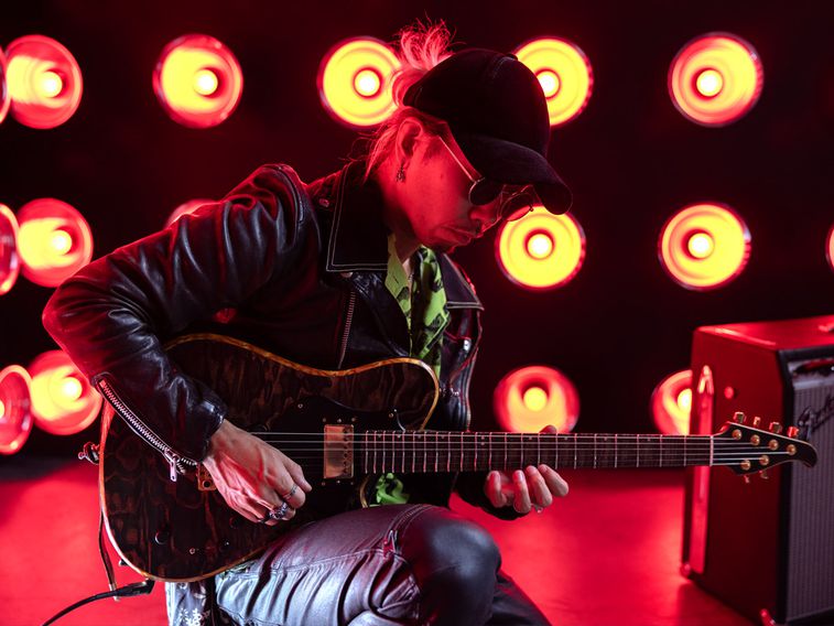 guitar player tuning his instrument